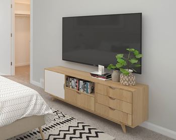 A modern living room with a flat screen TV on a wooden stand.